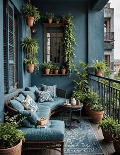 an outdoor patio with potted plants on the wall and a couch in the middle