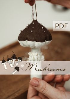 a person holding a small mushroom on top of a piece of paper with the words mushrooms above it