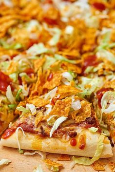 a pizza with lots of toppings sitting on top of a wooden cutting board