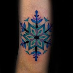 a snowflake tattoo on the arm