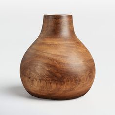 a wooden vase sitting on top of a white table