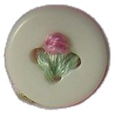 a white plate with a pink flower on the top and green leaves in the middle