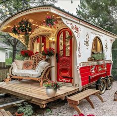 a small red and white house on wheels