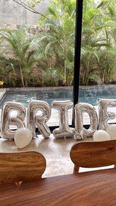 some balloons that are sitting in front of a window with the word bridal on it