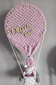 a hot air balloon with a stuffed animal hanging from it's side and the word prop on top