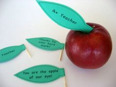 an apple with four leaves attached to it