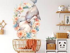 a dolphin and its baby in a floral wreath wall decal on a white wall