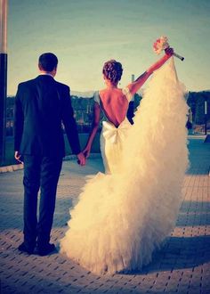 a man and woman holding hands walking down the street with one day written on it