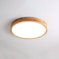 a wooden light fixture on a white wall