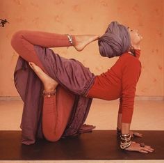 a woman is doing yoga on the floor