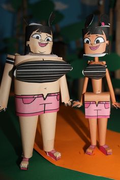 two paper dolls are standing next to each other