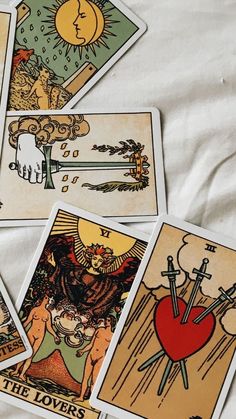 four tarot cards with images of people and animals in them on a white sheet