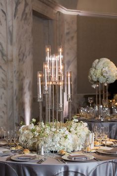 the centerpieces are surrounded by candles and flowers