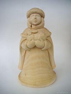 a wooden statue of a person holding a baby