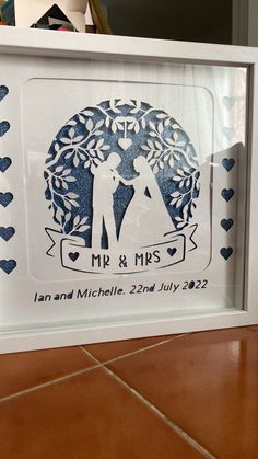 a wedding shadow box with a couple holding each other