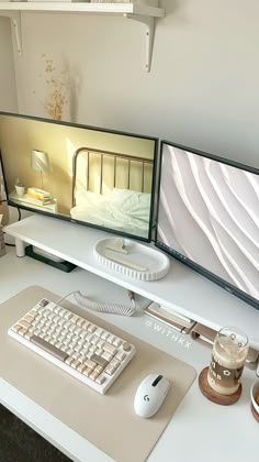 two computer monitors sitting on top of a white desk