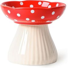 a red and white polka dot bowl sitting on top of a table