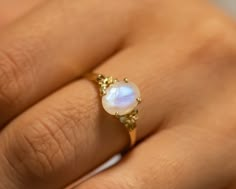 This is an oval moonstone ring, vintage style moonstone engagement ring, solitaire ring, moonstone engagement ring, gemstone ring, moonstone gold ring, oval engagement ring, a perfect moonstone engagement ring. Moonstone is a beautiful gemstone with a rich history and symbolism. Its association with the moon and its mystical properties make it a perfect alternative engagement ring.  The vintage-style floral design adds a touch of elegance and charm to the ring. The solitaire setting with a natur Unique Engagement Rings Moonstone, Moon Stone Engagement Ring Vintage, Moonstone Engagement Ring Gold, Ethereal Moonstone Wedding Ring With Rose Cut Diamonds, Heirloom White Moonstone Ring With Rose Cut Diamonds, Moonstone Gold Ring, Ethereal Moonstone Ring For Anniversary, Delicate White Moonstone Gemstone Ring, Delicate White Moonstone Ring