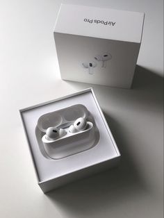 an open box with two airpods in it on top of a white countertop