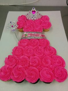 a cupcake dress made out of pink frosting with a tiara on top