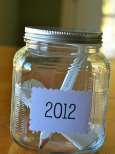 a mason jar with a label that says 2012 on it and some paper clips stuck in the jar