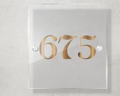 a glass plaque with the number sixty five on it