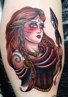 a woman with tattoos on her arm holding a knife