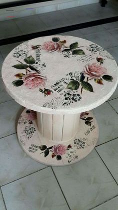 a white table with flowers painted on it