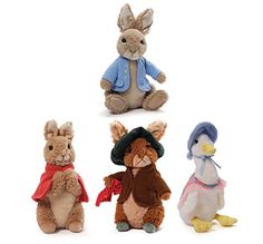 four stuffed animals in different outfits and hats