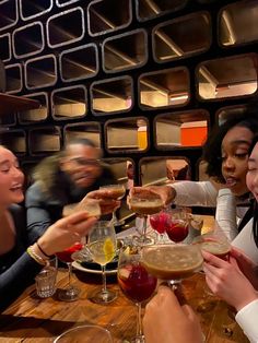 a group of people sitting at a table with wine glasses