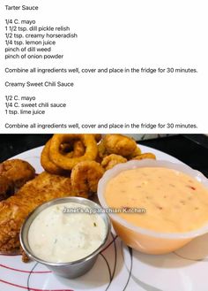 a plate with onion rings and dipping sauce on it