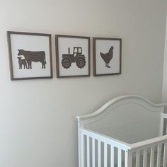 three framed pictures hang on the wall above a crib