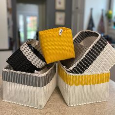 two woven baskets sitting on top of a counter