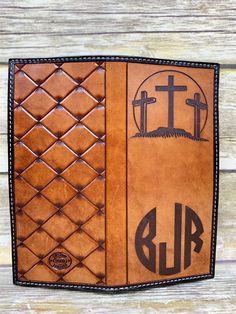 a brown leather bible cover with three crosses on it