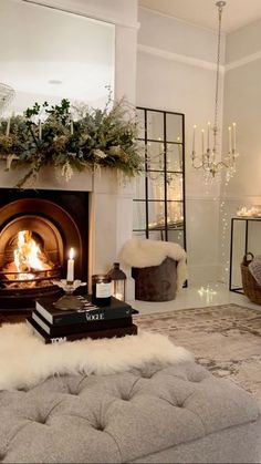 a living room filled with furniture and a fire place next to a fireplace covered in greenery