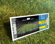 a ticket sitting on top of a lush green field filled with lots of tall grass