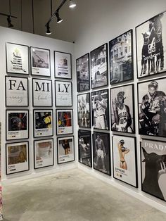 a room filled with lots of framed pictures on the wall