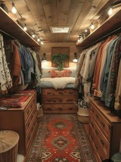 the inside of a small closet with lots of clothes and rugs on the floor