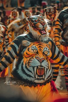 a group of people with painted tigers on their body