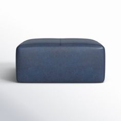 a blue ottoman sitting on top of a white floor