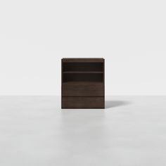 an empty bookcase on a white floor