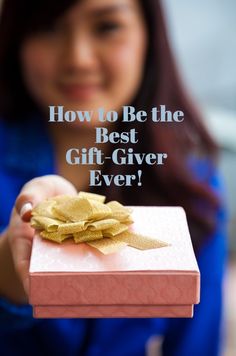 a woman holding a pink gift box with gold ribbon and the words how to be the best gift giver ever