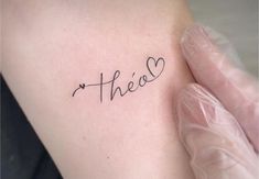 a person with a tattoo on their arm that says,'thee'in cursive writing