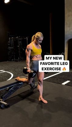 a woman standing on top of a bench in a gym