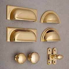 brass handles and knobs on a gray surface