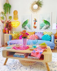 a living room filled with colorful furniture and decor on top of a white carpeted floor