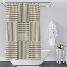 a white bath tub sitting next to a shower curtain