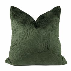 a green velvet pillow with an intricate design on the front and back, sitting on a white background