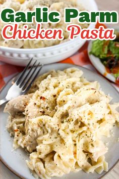 garlic parm chicken pasta on a plate with a fork