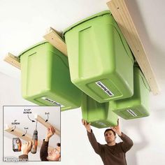 two men are working on the ceiling with green bins